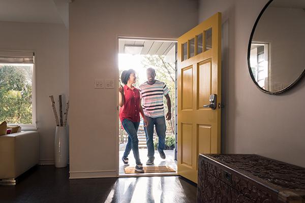 couple walking in front door