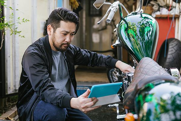 young man fixing a motorcycle