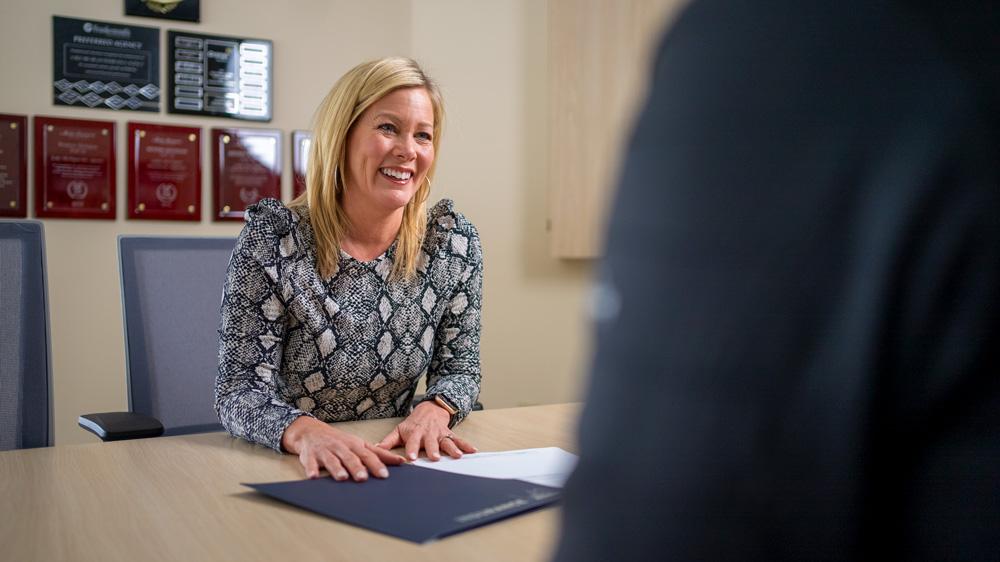 image of smiling agent helping clients